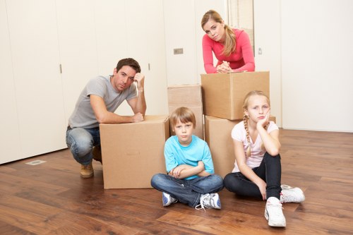 Professional movers carrying boxes during an urgent same day relocation
