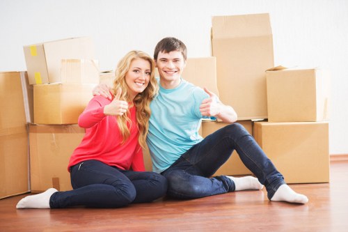 Local movers handling office equipment in a Camberwell street